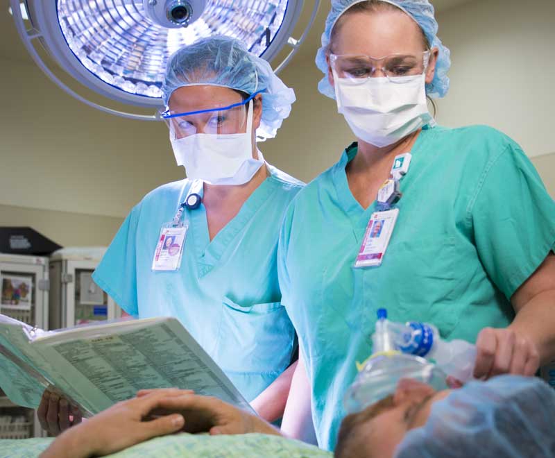 Two nurses with a patient in surgery
